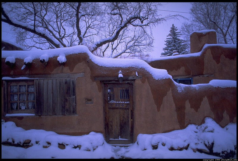 Snow-covered adobe house