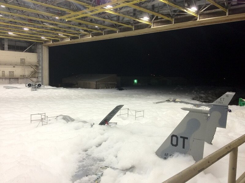 Snow-covered aircraft in hangar