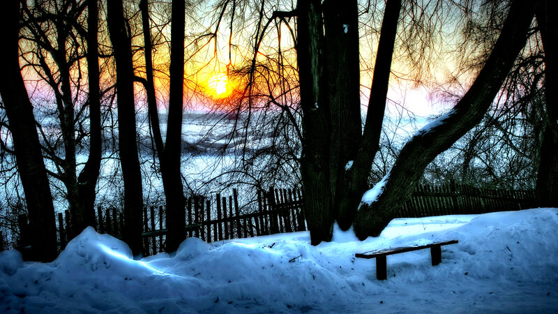 Snow-covered Bench at Sunset