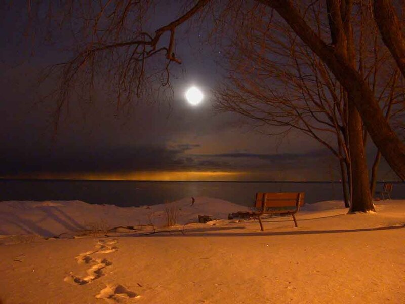 Snow-covered Bench by Lake — Orange, Serene, Night