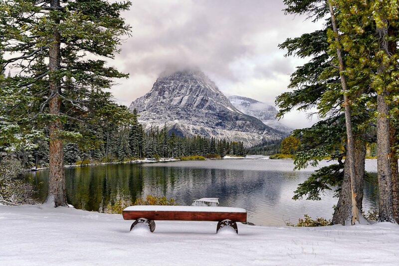 Snow-covered Bench by Lake — White, Serene, Winter, Photograph, Mountain, Trees
