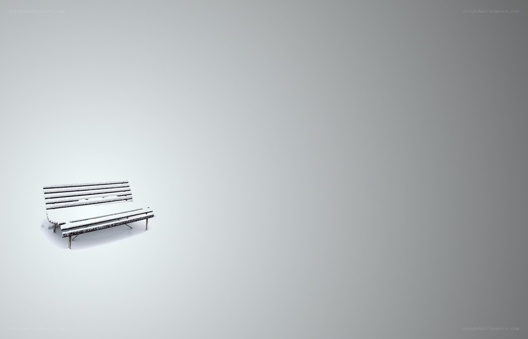Snow-covered bench in winter