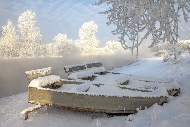 Snow-covered Boat on Riverbank — White, Serene, Winter