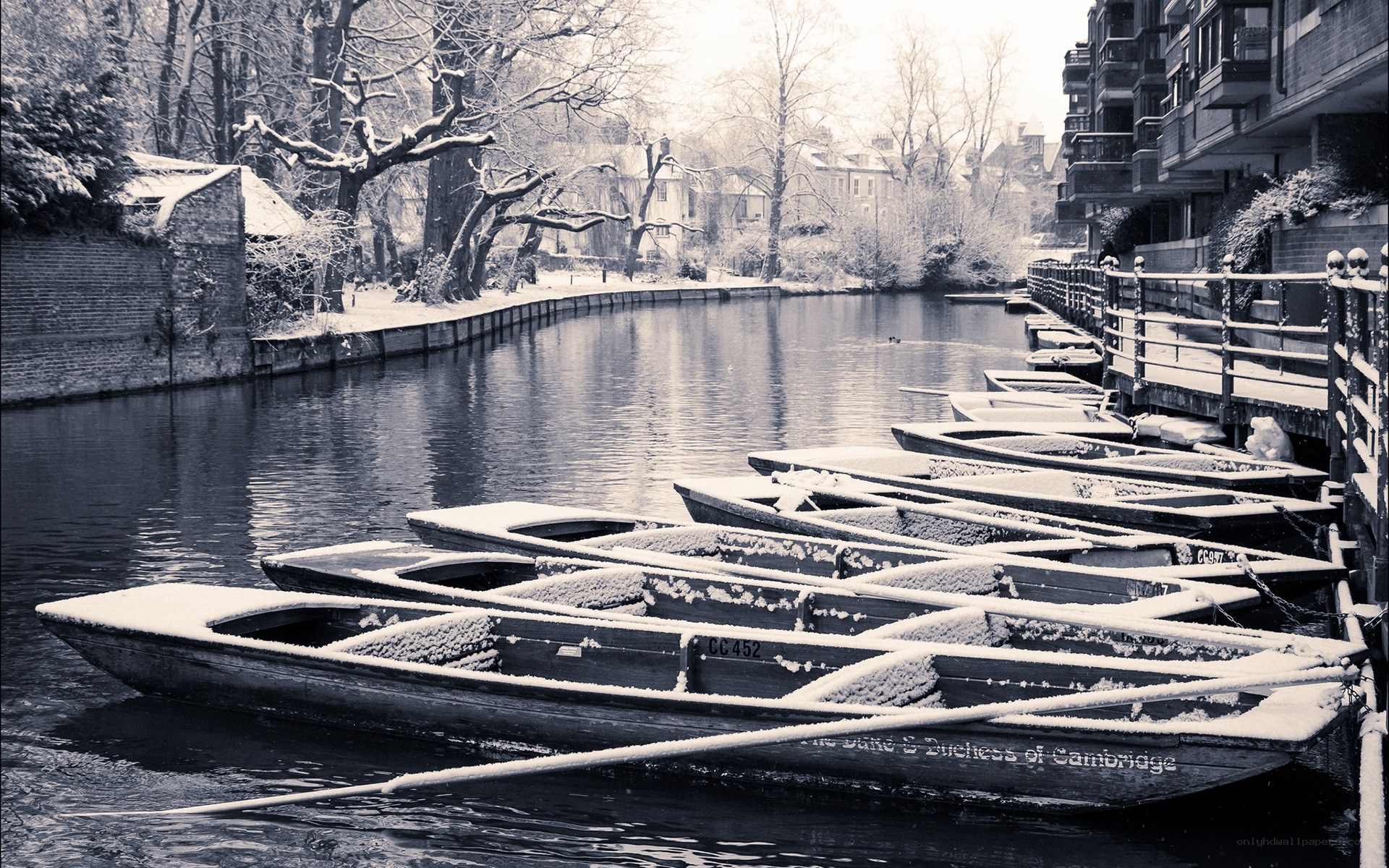 Snow-covered boats on a river