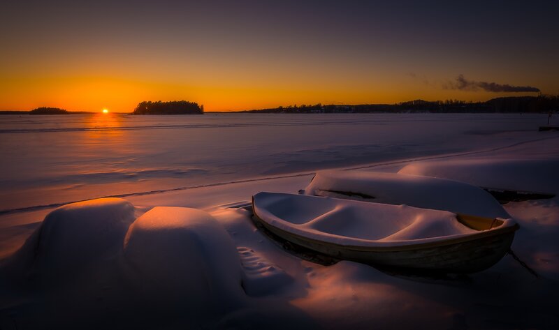 Snow-covered Boats on Ice