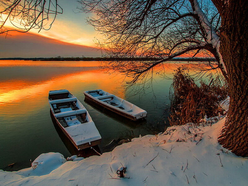Snow-covered Boats on Lake