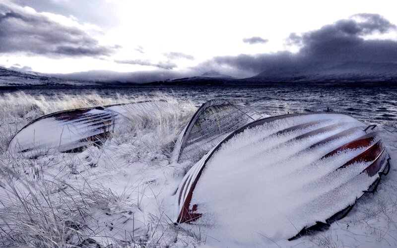 Snow-covered Boats on Shore