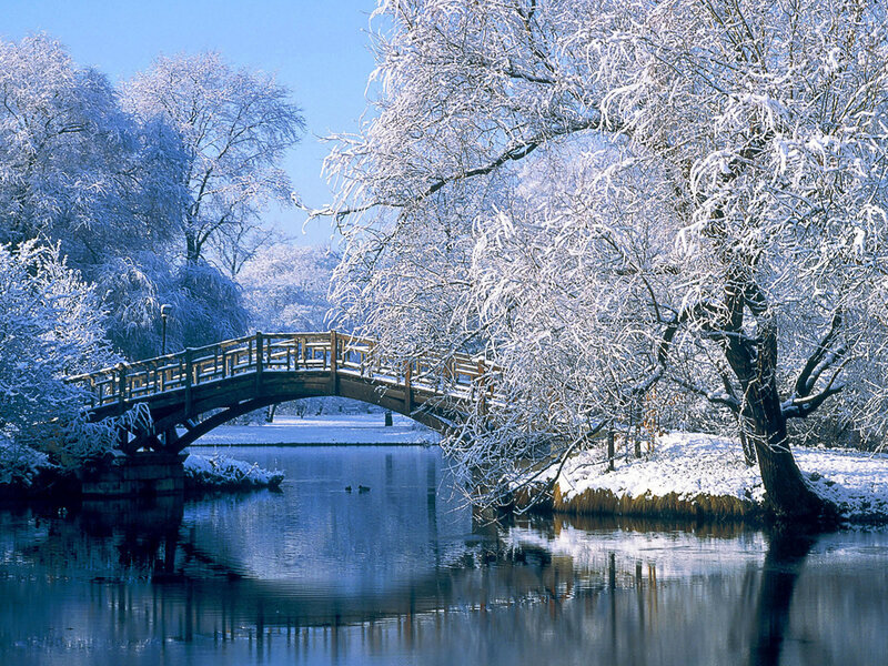 Snow-covered Bridge over River