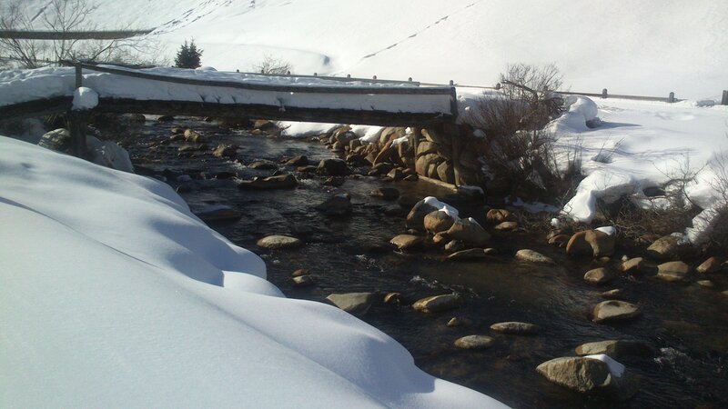 Snow-covered Bridge over Stream — White