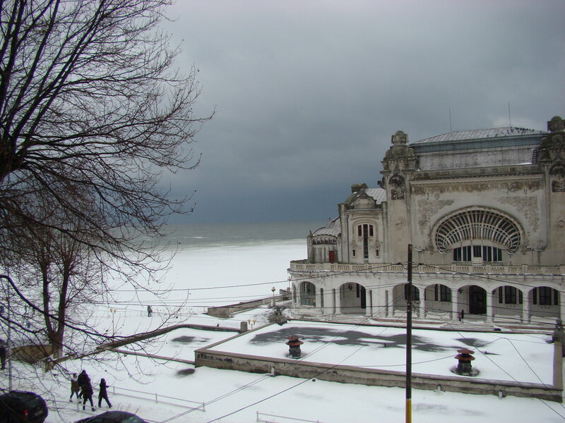 Snow-covered Building by Sea