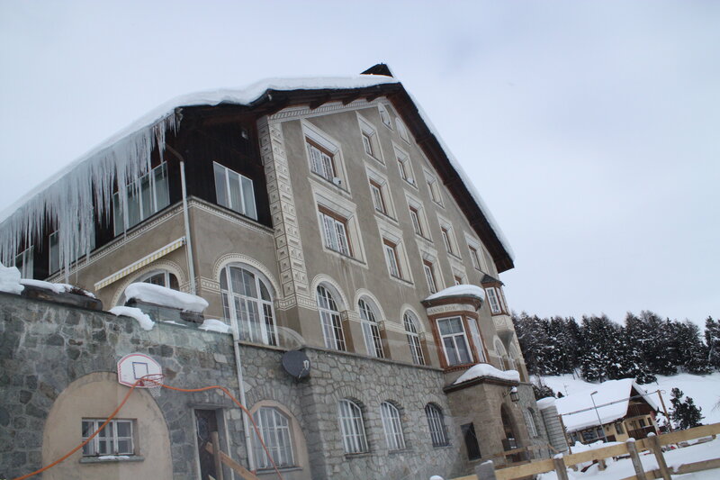 Snow-covered building with icicles