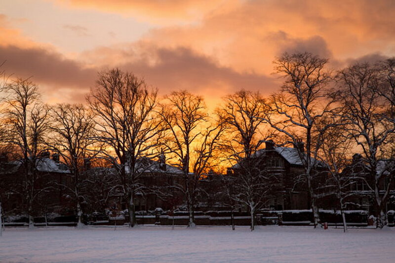 Snow-covered Buildings at Sunset