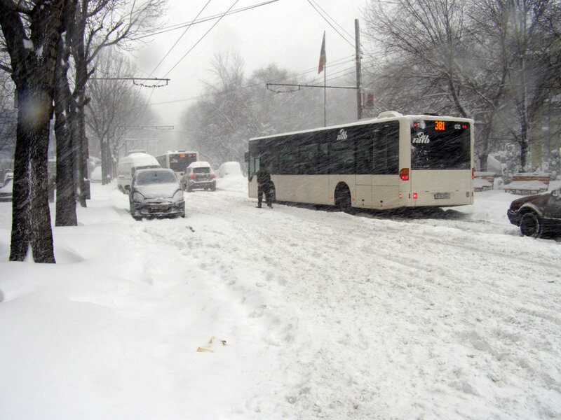 Snow-covered Bus on Street