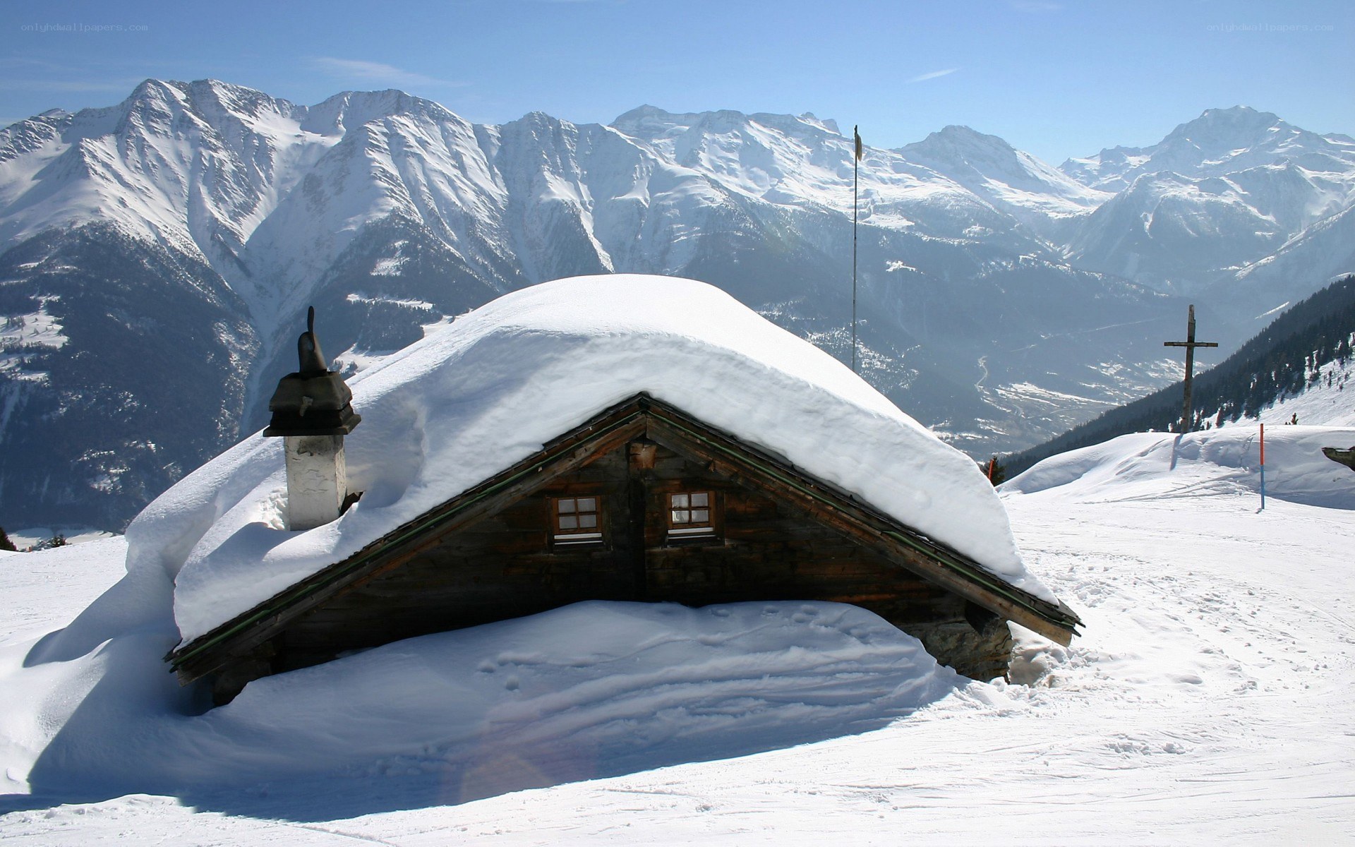 Snow-covered cabin in mountains