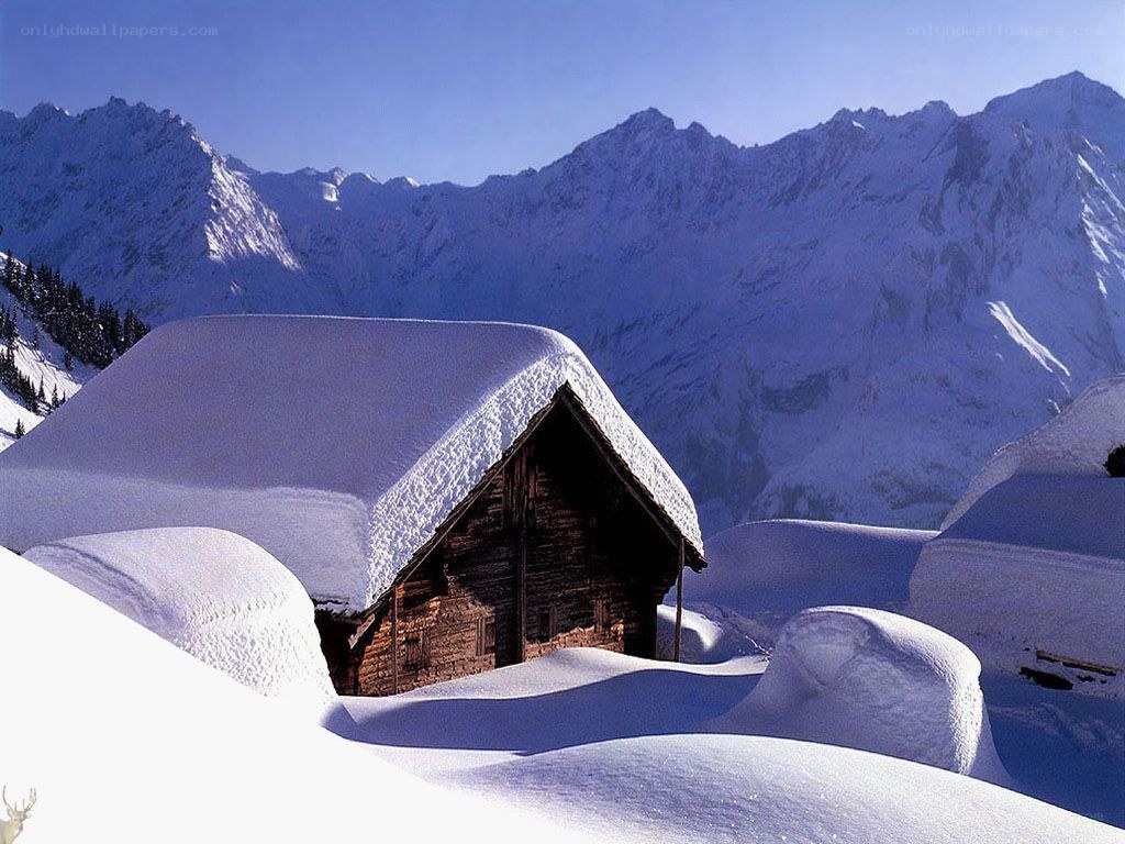 Snow-covered cabin in mountains