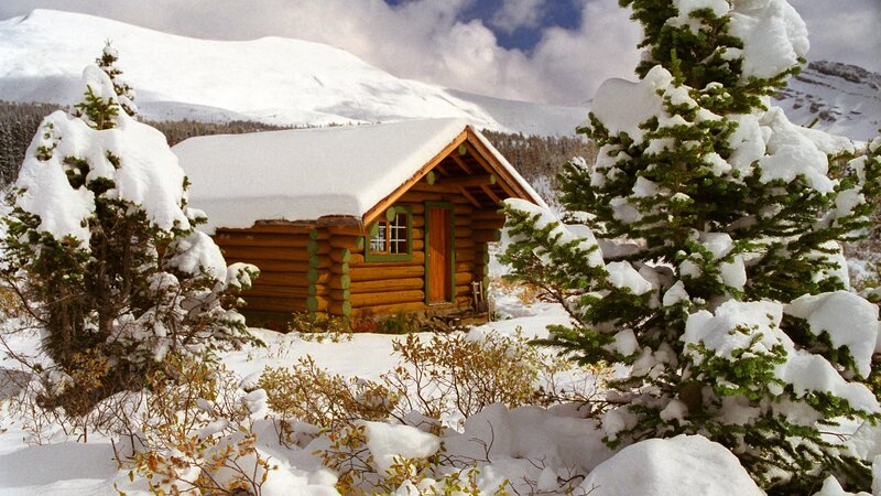 Snow-covered cabin in mountains