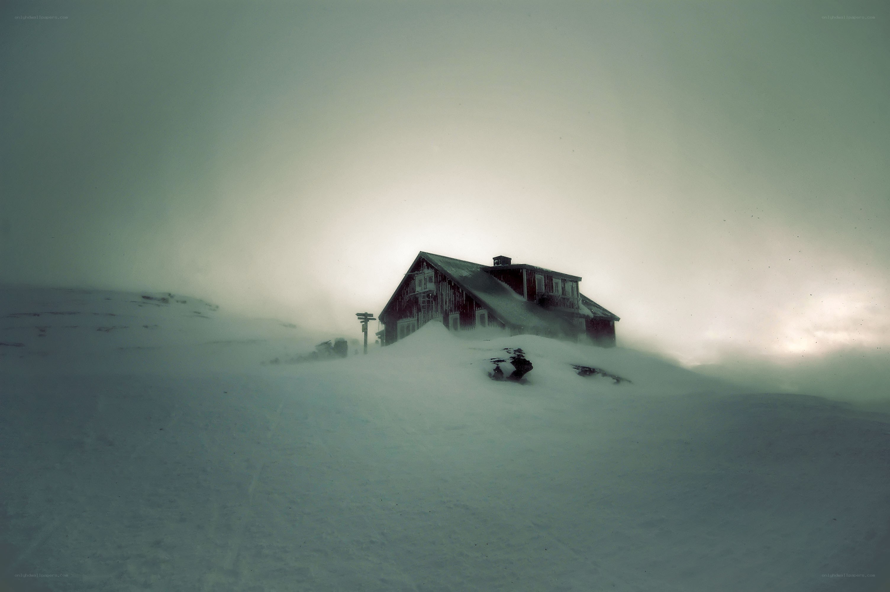 Snow-covered cabin in storm