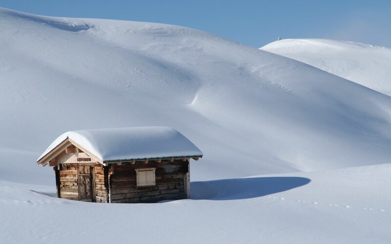 Snow-covered cabin in winter