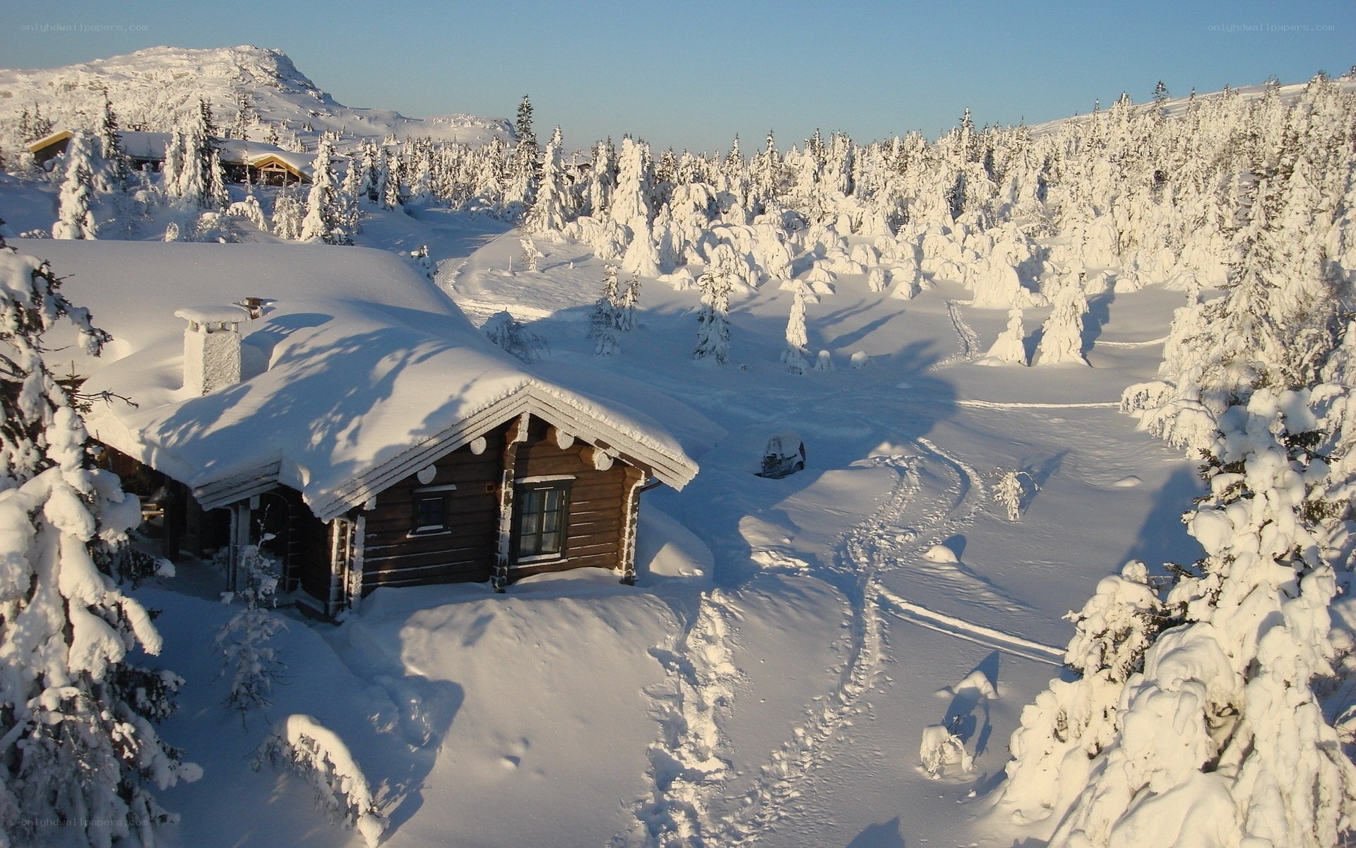 Snow-covered cabin in winter landscape