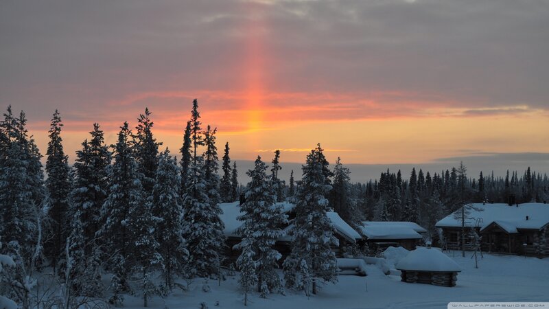 Snow-covered Cabins at Sunset