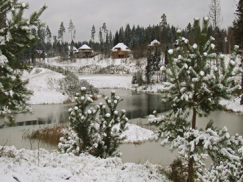 Snow-covered Cabins by Lake
