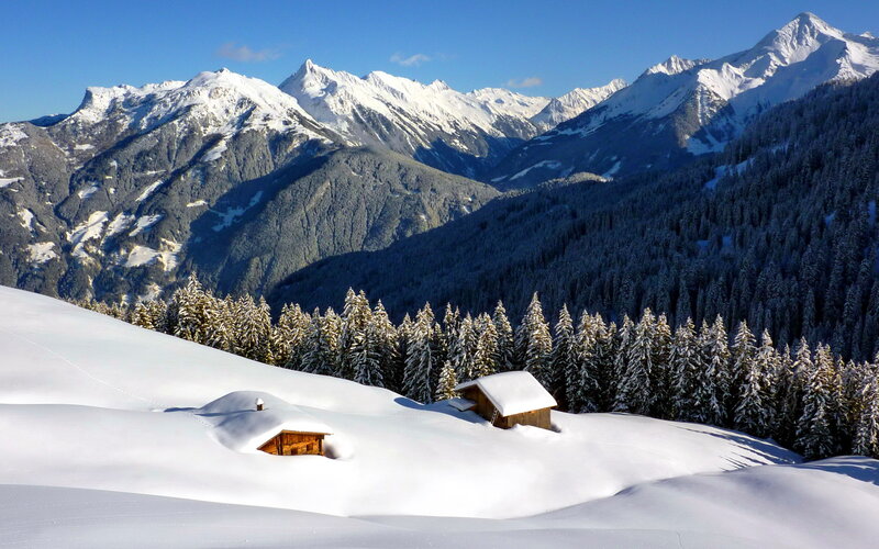 Snow-covered Cabins in Mountains