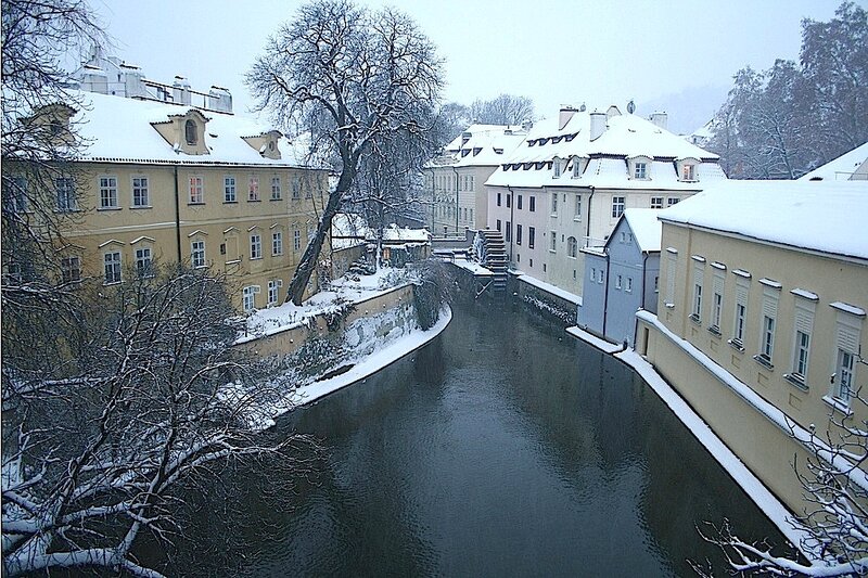 Snow-covered Canal in City