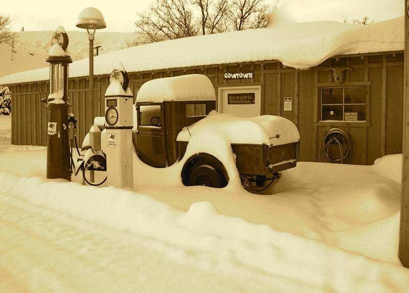 Snow-covered Car at Gas Station