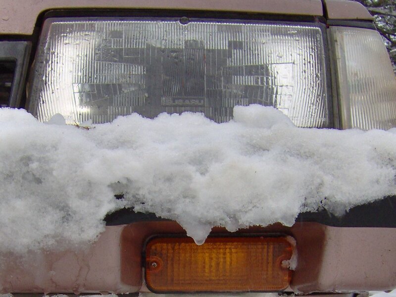 snow-covered car headlight