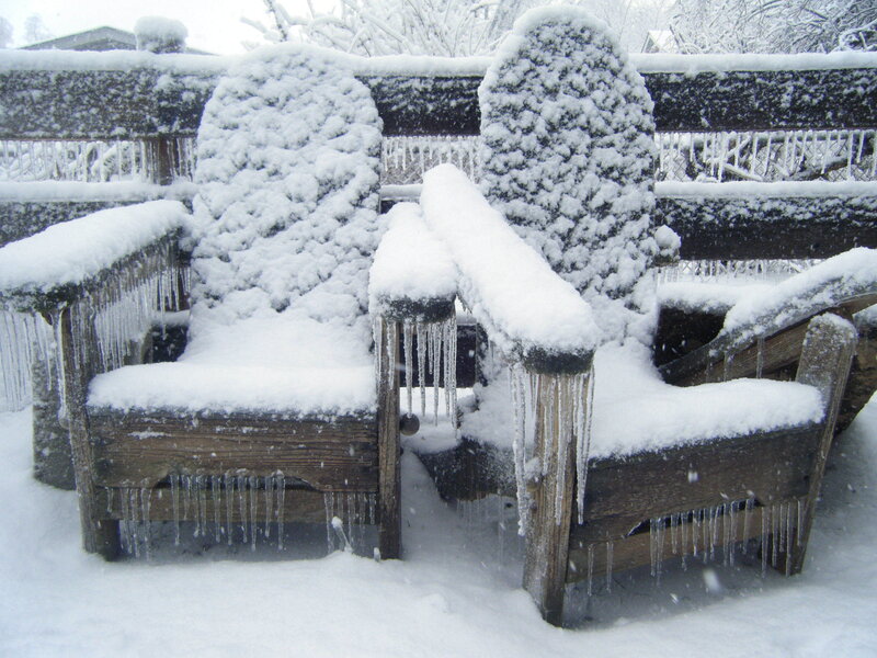 Snow-covered chairs in winter