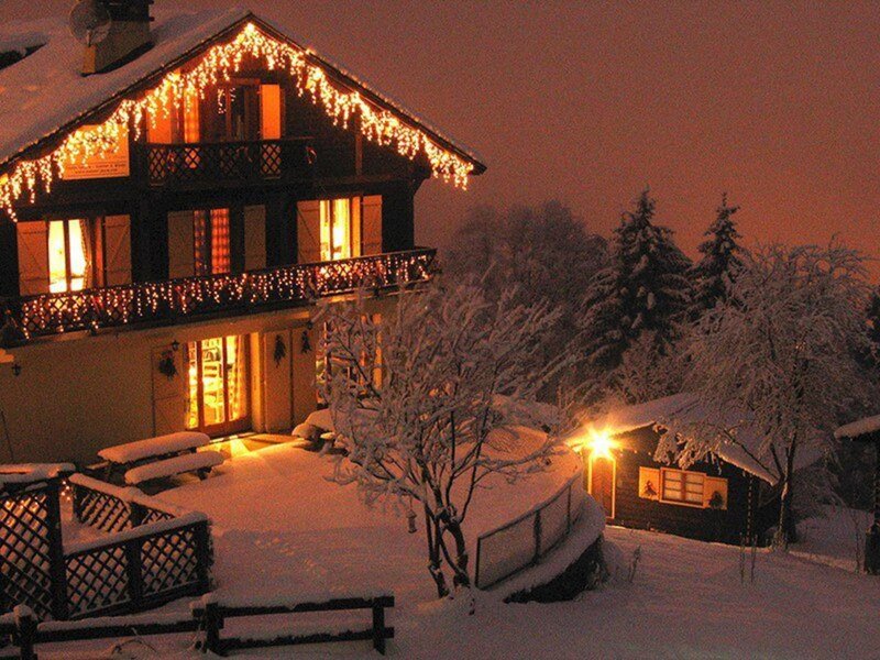 Snow-covered Chalet at Night