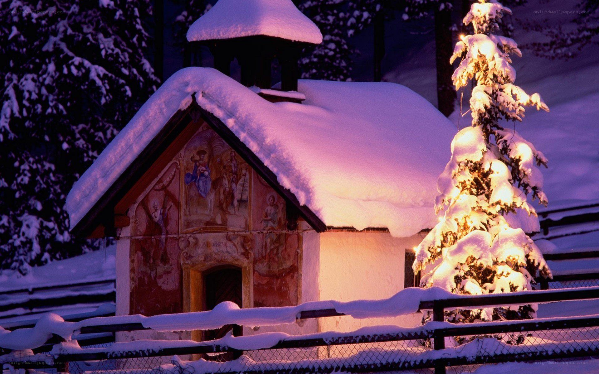 Snow-covered chapel at dusk