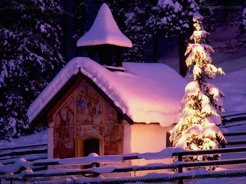 snow-covered chapel at night