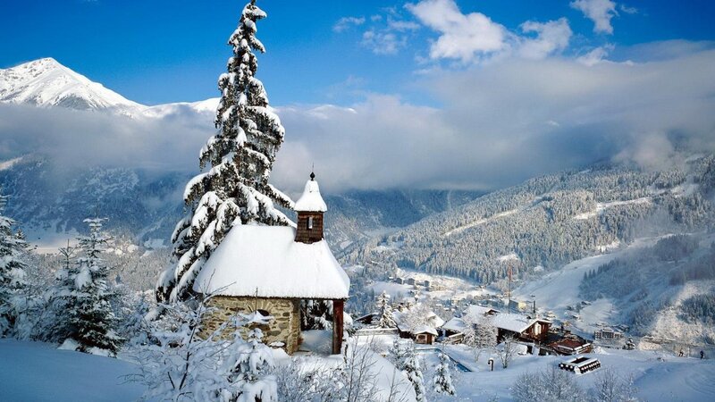 Snow-covered Chapel in Mountains
