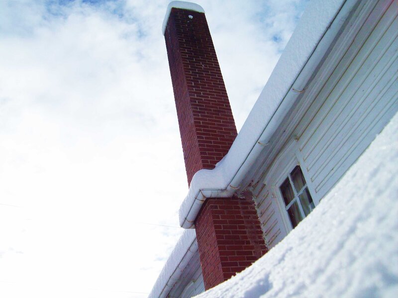 snow-covered chimney on a house