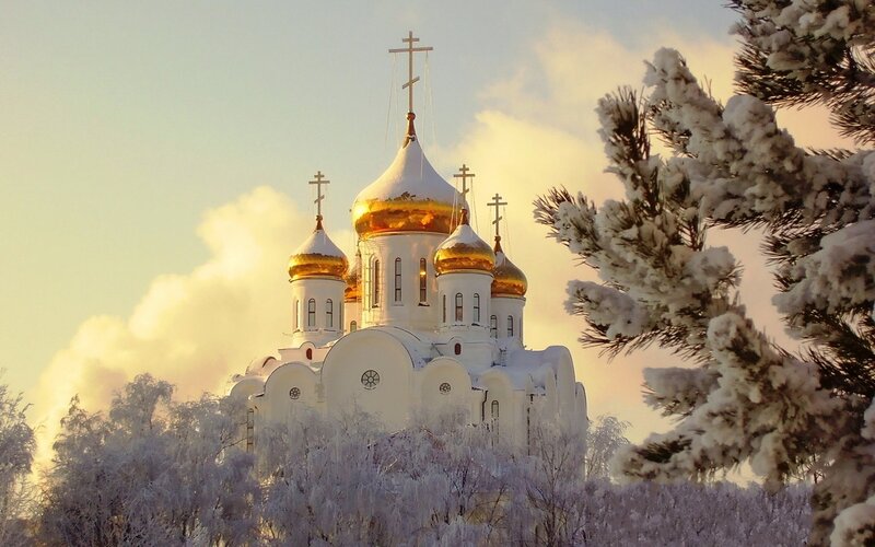 Snow-covered church at sunrise