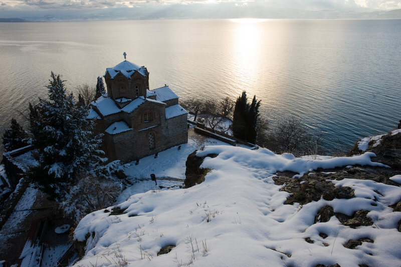 Snow-covered Church by Lake