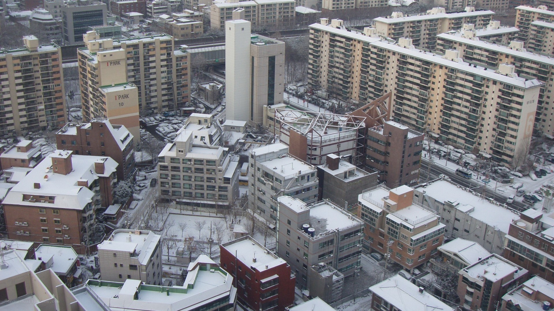 Snow-covered city apartment buildings