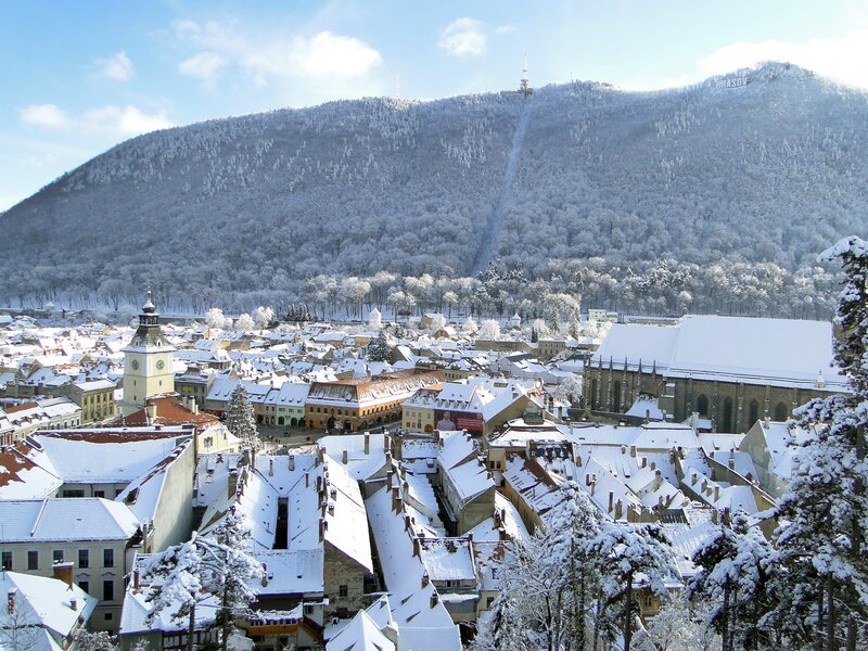 Snow-covered city with mountain view