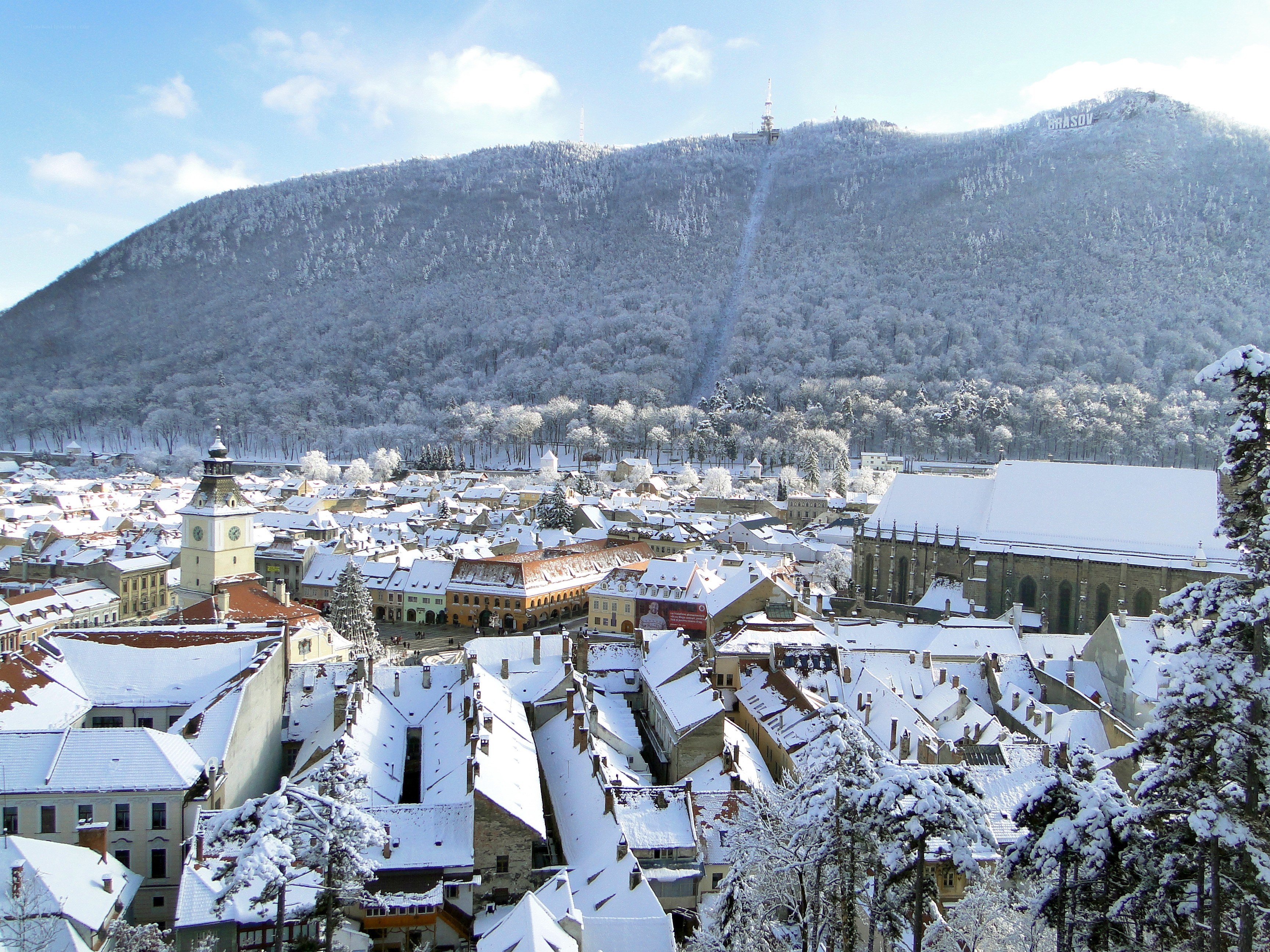 Snow-covered city with mountain view
