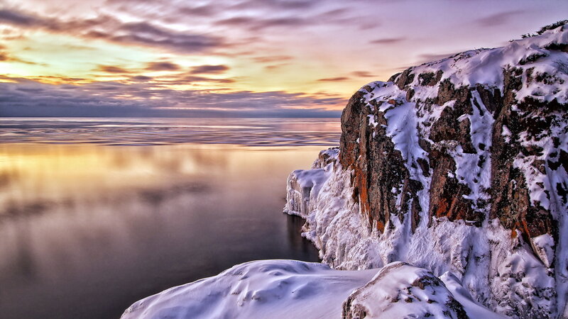 Snow-covered Cliff by Water