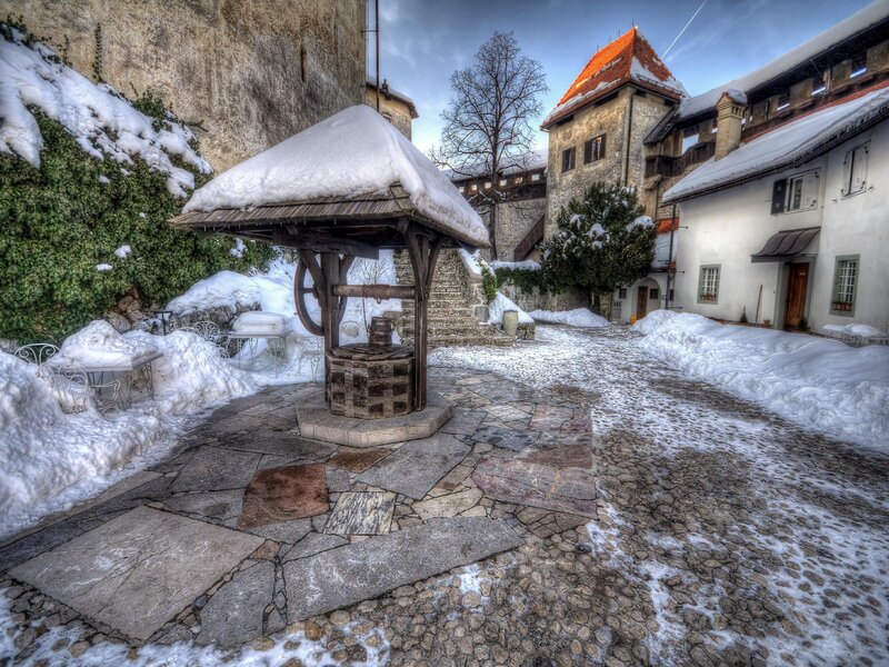 Snow-covered courtyard with well
