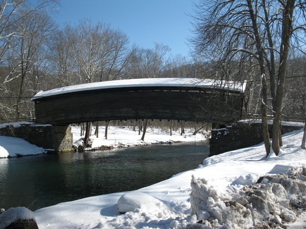snow-covered covered bridge