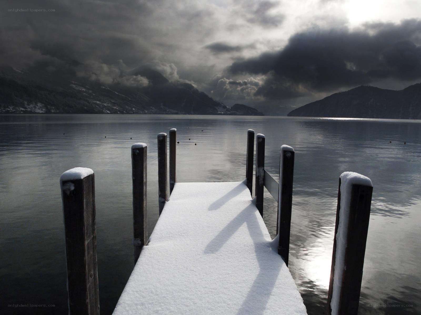 Snow-covered dock on a lake