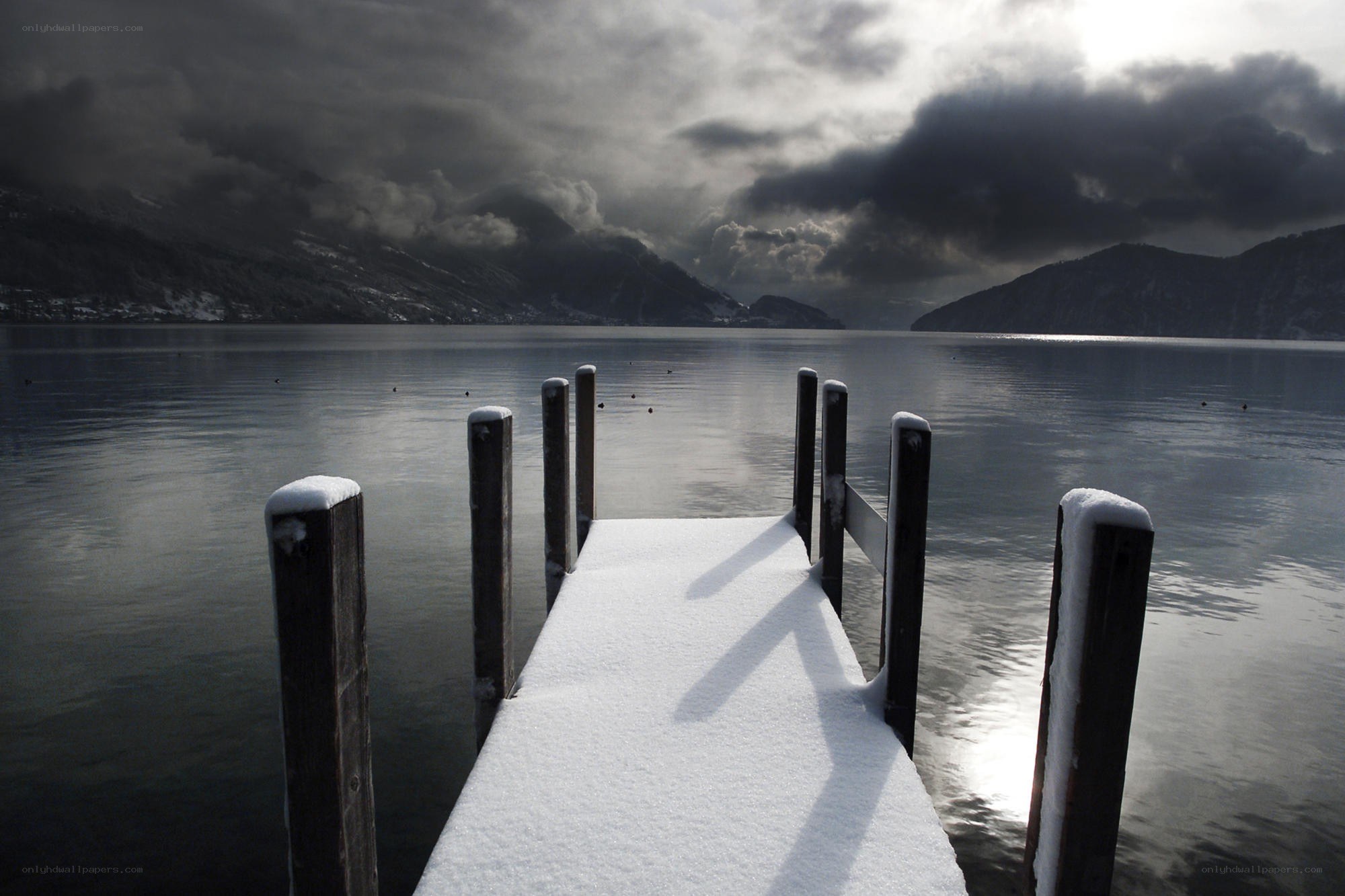 Snow-covered dock on a lake