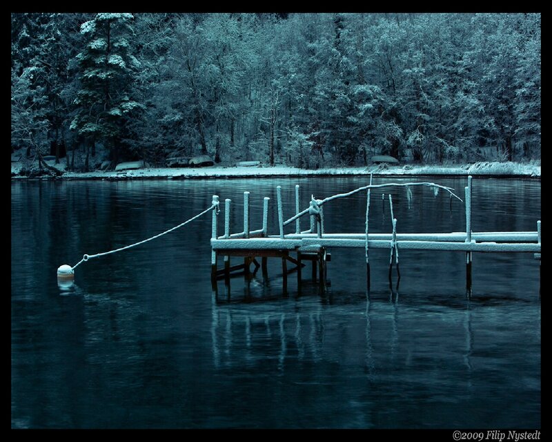 Snow-covered dock on a lake
