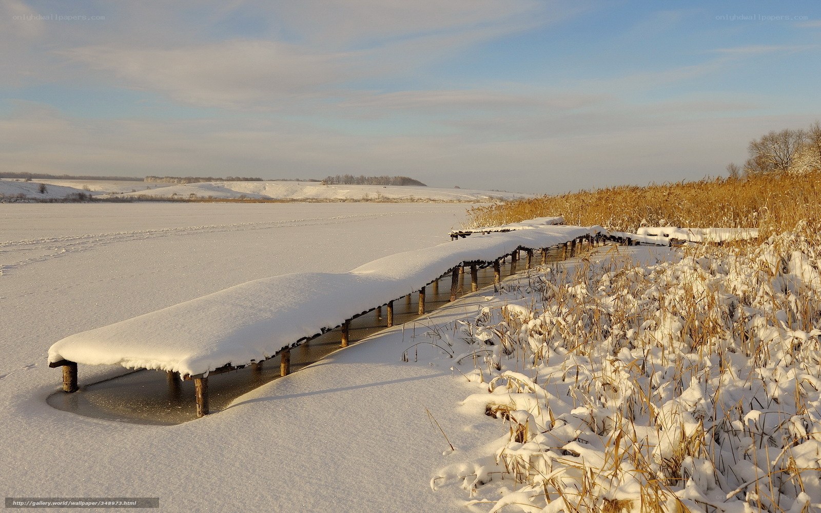 Snow-covered dock on frozen lake