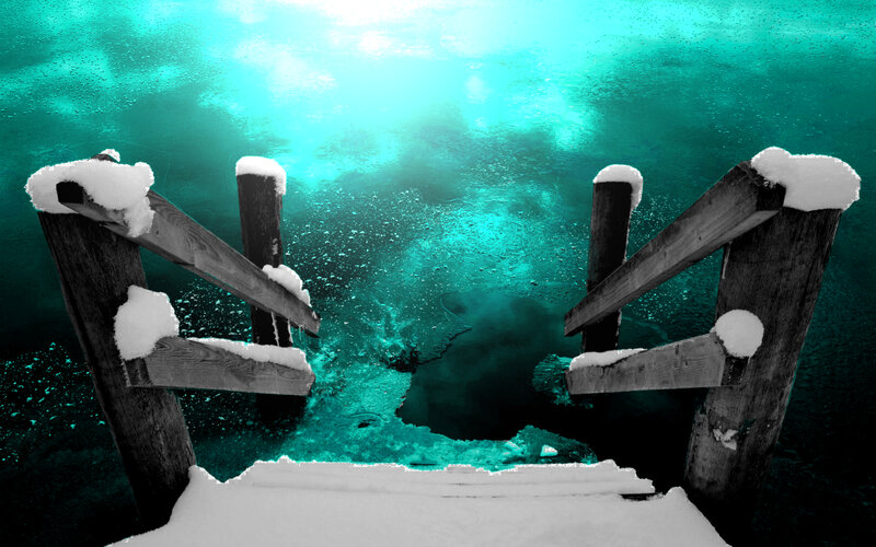 snow-covered dock under turquoise water