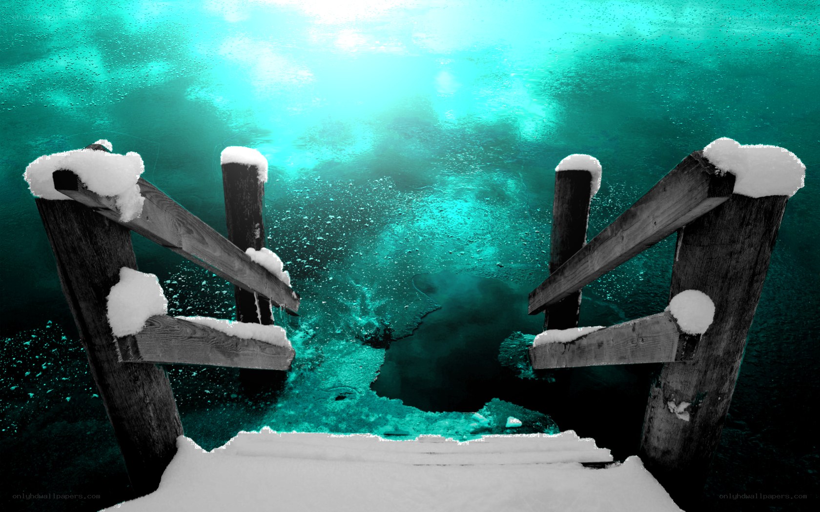 snow-covered dock under turquoise water