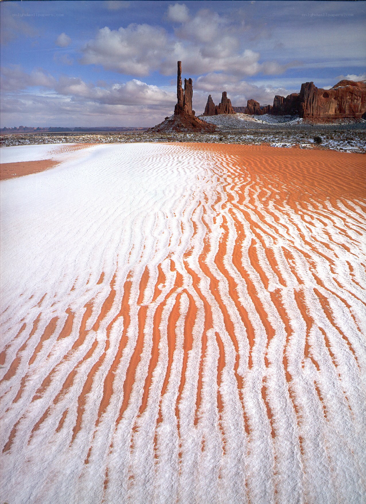 Snow-covered dunes with rock formations